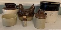 All six crockery items including the large bean pot, hen dish, crockpot, milk jug and two smaller containers arranged together for overview.