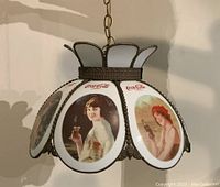 Front view of the Coca-Cola Tiffany style hanging light fixture showing the glass panels with vintage Coca-Cola images of women.