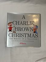 Front cover photo of the book 'A Charlie Brown Christmas: The Making of a Tradition' showing cartoon characters Charlie Brown and Linus.