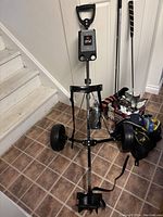 Golf pull cart with black frame and large wheels shown from front angle.