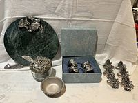 Marble tray with pewter grape-shaped spreader, covered glass bowl with pewter grape cluster lid and spoon, small pewter dish, four floral pewter napkin rings in box, and six grape motif pewter napkin rings not marked Seagull.
