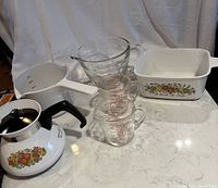 Photo of entire lot with teapot, casserole, glass measuring cups from Fire King and Pyrex