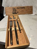 Full view of Arthur Salm 3-piece carving set in original wood box with sliding lid, showing two carving knives and one carving fork.