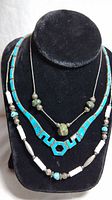 Front view showing all three necklaces on display with turquoise and silver elements.