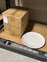 Box labeled "Porcelain Round 11 1/4" Plate." Plate displayed beside the box showing size and shape.