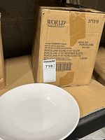 World Tableware box label detailing contents as 12 porcelain round plates 11 1/4 inches.