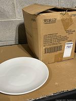 Photo of box labeled 'World Tableware' with plate in front, showing brand and product details.