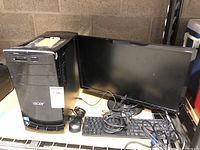 Full view of Acer Aspire M3970 desktop with monitor, keyboard, and mouse on table