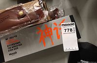 Box with HUUSK branding and two leather sheaths in plastic wrapping, showing original packaging and sheath details.