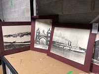 Three black and white historical photos on plaque boards shown side by side, displaying their size and aging condition.