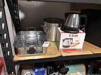 Overview of the roasting pan, large pot, and T-fal kettle on shelf