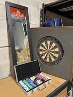 Poker set with multicolored chips, cards and dice inside a silver metal carrying case, open to show contents