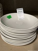 Stack of 12 white restaurant style Evolve Coupe bowls by Churchill Dining Out.