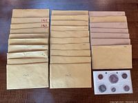 Brown paper envelopes labeled ‘1967’ arranged in three columns, approximately 28 envelopes total