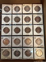 First binder page showing 25 half-dollar coins in flips
