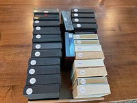 Overhead view of 26 presentation cases in black and tan showing year labels