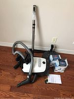 Overall view of vacuum body, hose, wand, powerhead, attachments and filter boxes