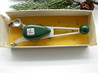 Side view of vintage Faber Castell Scriber 1200 draftsman's tool showing adjustment knobs and sharp scriber tip.