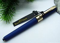 Close-up photo of the French blue pen with gold accents and attached Bruno Visconti tag.