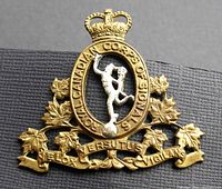 Front detail of the fire gilt brass cap badge with frosted figure and maple leaves
