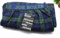Folded Joe Boxer flannel plaid pajama pants showing the elastic waistband with 'JOE BOXER' branding and original tags attached.