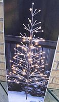 Box showing lit Noma Winter Forest Tree with minimalist branch LED design.