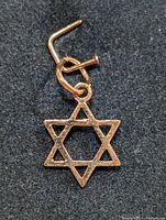 Close-up of 10K gold Star of David pendant with loop for chain.