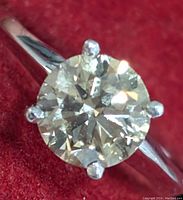 Front view close-up of round brilliant diamond and six-prong setting