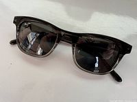 Front view of Maui Jim men's sunglasses showing dark translucent frame and polarized lenses.