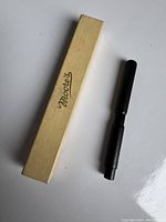 Cream colored rectangular box with cursive 'Moore's' branding against white background.