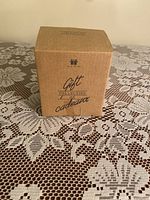 Avon Gift Collection cardboard box on lace tablecloth, showing brand and series name