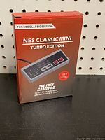 Front view of the NES Classic Mini Turbo Edition controller box showing branding and product details including 'The Edge Gamepad' and '10 FT Long' cable specification.