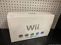 Original Wii Sports edition box showing front with Wii Sports game icons and Wii logo on white box with wear and creases.