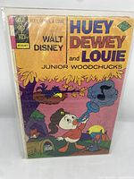 Front cover of Walt Disney's Huey, Dewey, and Louie #12 comic showing characters and publisher logo with price.