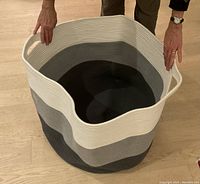 Photo showing new tri-color cotton rope basket with built-in side handles, sized 24x24x17 inches.