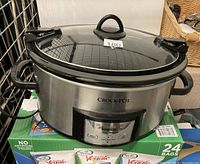 Front view of the Crock-Pot showing the control panel and glass lid with black handle on top.