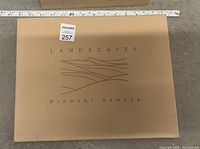 Cover of photography book featuring title 'LANDSCAPES' and author name Hiroshi Hamaya on a light brown background with minimalist abstract landscape design.