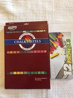 Closed box of Pro Art Chalk Pastels containing 24 colors in original packaging, burgundy box with cutout windows showing pastel colors.