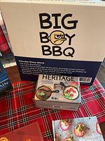 Box of Big Boy BBQ circular pizza stone with details on diameter (15 inch) and thickness (15 mm).