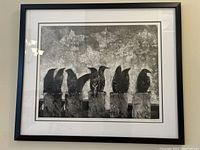 Framed black and white art print of starlings on chimney pots, showing the full frame and artwork.