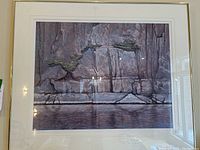 Full view of framed print showing textured rock face and water reflection