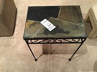 Top view of the table showing the multicolored slate stone top with natural patterns and wear marks.