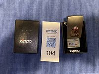 Zippo lighter in black box showing beaver design and MaxSold tag