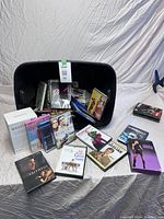 Photo of movie tote showing a mix of DVDs and Blu-rays including The River's End, Unfaithful and Crash