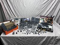 Overview of lot showing multiple sprue frames, assembled miniatures and two Games Workshop product boxes