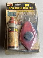 Photo of set in original blister pack showing chalk bottle and chalk line reel.
