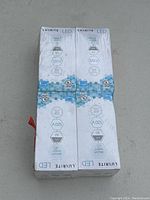 Photo of the side and top of the four LED bulb boxes showing voltage, wattage, and technical specifications.