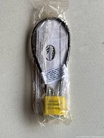 Project ChildSafe yellow cable lock sealed in plastic packaging showing lock and cable length