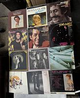 Overview of all 12 vintage vinyl record albums laid out in a grid, showing front covers with various artists and designs.