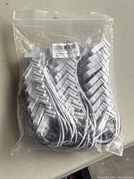 Plastic bag containing 30 white plastic lamp holders for T8 fluorescent tubes with attached wires, showing quantity and item type.